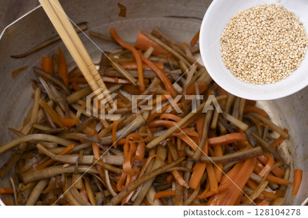 在廚房製作金平牛蒡的步驟：添加白芝麻 128104278