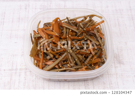 Transfer the prepared Kinpira Gobo to a storage container. Transfer the prepared Kinpira Gobo to a storage container. 128104347