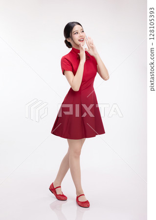 Full body portrait of joyful beauty Asian woman in red Cheongsam Chinese traditional dress celebrating and announcing isolated on white background. 128105393