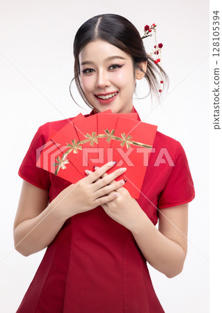 Portrait of joyful beauty Asian woman in red Cheongsam Chinese traditional dress celebrating with lucky red envelopes on Chinese New Year festival isolated on white background. Portrait of joyful beauty Asian woman in red Cheongsam Chinese traditional dress celebrating with lucky red envelopes on Chinese New Year festival isolated on white background. 128105394