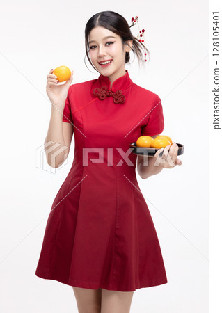 Portrait of joyful beauty Asian woman in red Cheongsam Chinese traditional dress celebrating with lucky fresh oranges on Chinese New Year festival isolated on white background. 128105401