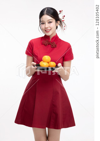 Portrait of joyful beauty Asian woman in red Cheongsam Chinese traditional dress celebrating with lucky fresh oranges on Chinese New Year festival isolated on white background. 128105402