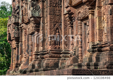Beautiful bas relief in Banteay Srei a 10th century Cambodian temple dedicated to the Hindu god Shiva made by pink and red sandstone in Siem Reap, Cambodia. Beautiful bas relief in Banteay Srei a 10th century Cambodian temple dedicated to the Hindu god Shiva made by pink and red sandstone in Siem Reap, Cambodia. 128106498