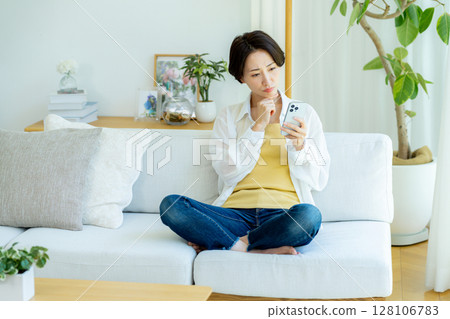 中年婦女在房間使用智慧型手機 128106783