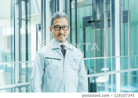 Middle-aged worker standing in an office building. Photo courtesy of Sky Perfect Tokyo Media Center. Middle-aged worker standing in an office building. Photo courtesy of Sky Perfect Tokyo Media Center. 128107345