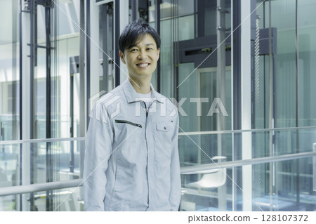 Smiling workers standing in an office building. Photo courtesy of Sky Perfect Tokyo Media Center. Smiling workers standing in an office building. Photo courtesy of Sky Perfect Tokyo Media Center. 128107372