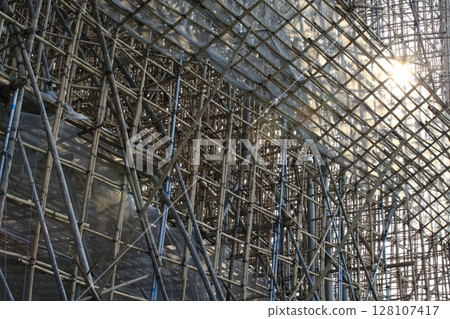 bamboo scaffolding pole cover the tower building wall cover the wan chai convention centre (HKCEE) , asian architectural background in hong kong china bamboo scaffolding pole cover the tower building wall cover the wan chai convention centre (HKCEE) , asian architectural background in hong kong china 128107417