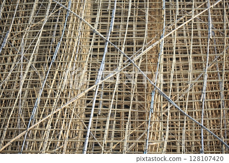 bamboo scaffolding pole cover the tower building wall cover the wan chai convention centre (HKCEE) , asian architectural background in hong kong china 128107420
