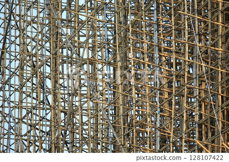 bamboo scaffolding pole cover the tower building wall cover the wan chai convention centre (HKCEE) , asian architectural background in hong kong china 128107422