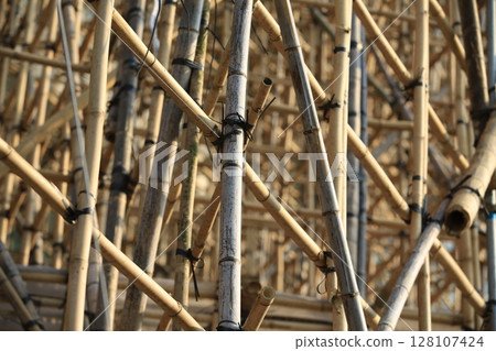 bamboo scaffolding pole cover the tower building wall cover the wan chai convention centre (HKCEE) , asian architectural background in hong kong china 128107424
