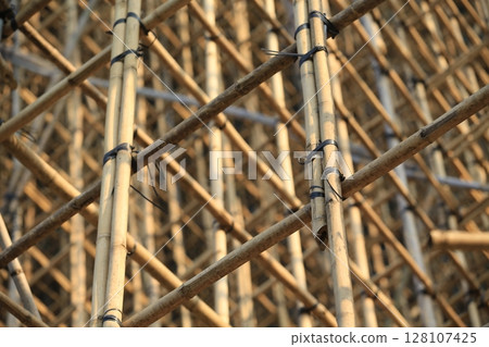bamboo scaffolding pole cover the tower building wall cover the wan chai convention centre (HKCEE) , asian architectural background in hong kong china bamboo scaffolding pole cover the tower building wall cover the wan chai convention centre (HKCEE) , asian architectural background in hong kong china 128107425