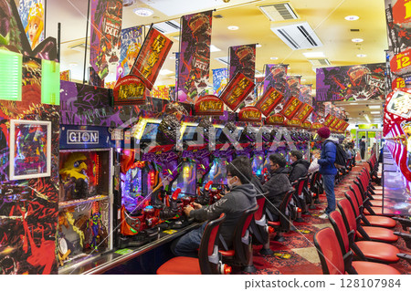 Okinawa, Japan - June 10,2019 : Unidentified people plays an arcade machines in Jumbo Pachinko Arcade in Naha, Okinawa, Japan on June 10,2019. 128107984