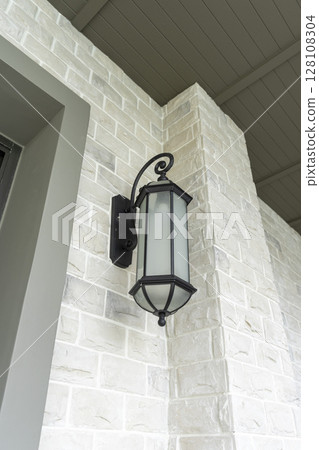 black wall lamp on a wall. Side view. 128108304