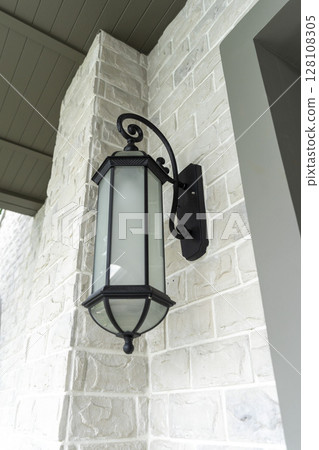 black wall lamp on a wall. Side view. black wall lamp on a wall. Side view. 128108305