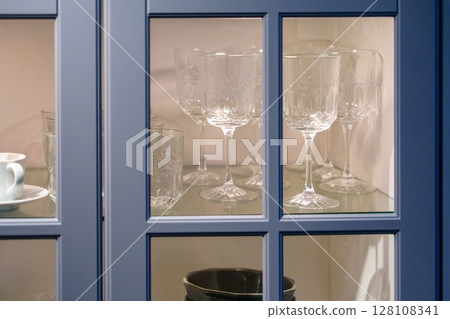 Elegant Glassware Displayed in a Stylish Blue Cabinet with Intricate Design, Home Decor 128108341