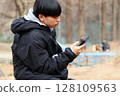 Junior high school boy looking at smartphone Asian Japanese 128109563