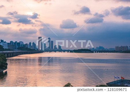 A view of the sunset city of Yeouido in the financial district taken on the Dongjak Bridge on the Han River in summer evening 128109671