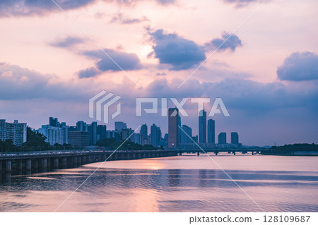 A view of the sunset city of Yeouido in the financial district taken on the Dongjak Bridge on the Han River in summer evening A view of the sunset city of Yeouido in the financial district taken on the Dongjak Bridge on the Han River in summer evening 128109687