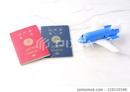 Image of a Japanese passport (red for 10 years and navy blue for 5 years) and an airplane planning a long holiday overseas trip Image of a Japanese passport (red for 10 years and navy blue for 5 years) and an airplane planning a long holiday overseas trip 128110166