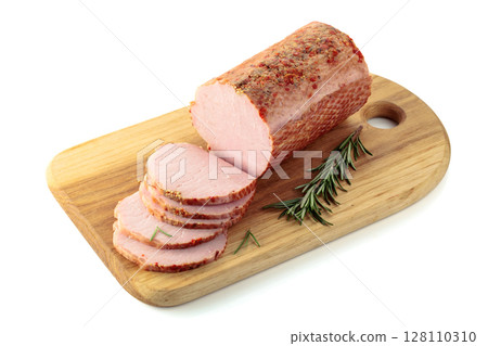 Sliced ham with rosemary on a cutting board. 128110310