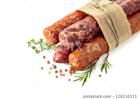 Dry cured sausages with spices isolated on a white background. 128110313