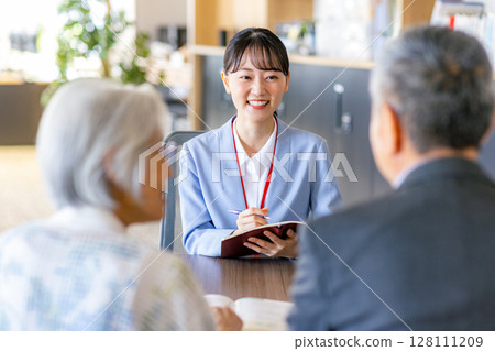 Senior couple consulting the window 128111209