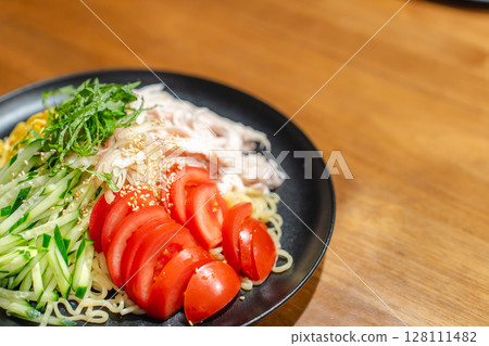 A moment of supper with cold Chinese noodles filled with ingredients 128111482