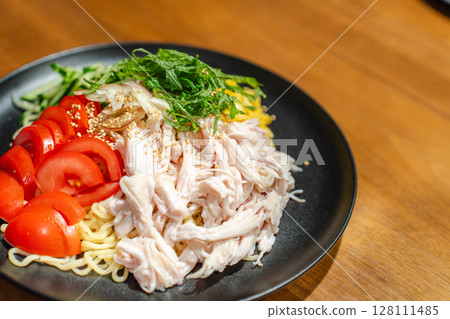 A moment of supper with cold Chinese noodles filled with ingredients 128111485