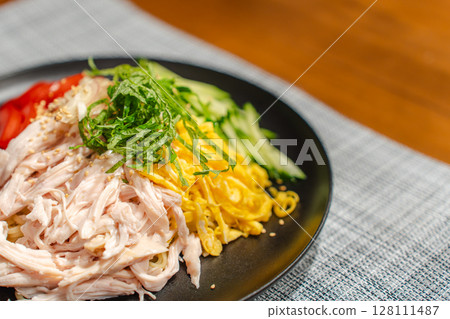 A moment of supper with cold Chinese noodles filled with ingredients A moment of supper with cold Chinese noodles filled with ingredients 128111487