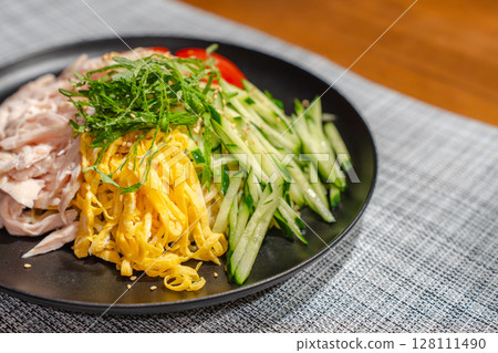 A moment of supper with cold Chinese noodles filled with ingredients A moment of supper with cold Chinese noodles filled with ingredients 128111490
