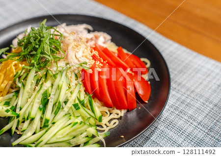 A moment of supper with cold Chinese noodles filled with ingredients 128111492