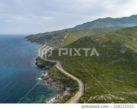 Aerial view car Roadtrip Winding road along rocky coast of Cap Corse peninsula on Corsica island France 128111513