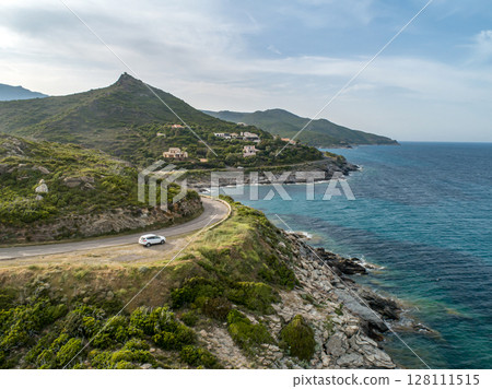 Aerial view car Roadtrip Winding road along rocky coast of Cap Corse peninsula on Corsica island France 128111515