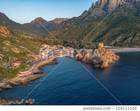 Aerial view town ruins Genoese tower of Porto Corsica France medieval watchtower Mediterranean Sea Calanches de Piana 128111520