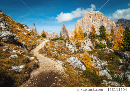 Spectacular hiking trail on the slope at autumn, Dolomites, Italy 128111594