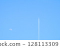 The moon and the plane floating in the blue sky 128113309
