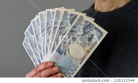 Person holding the new 1,000 yen note Person holding the new 1,000 yen note 128113544