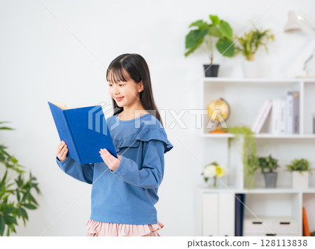 A girl reading a book A girl reading a book 128113838