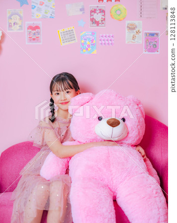 Portrait of a girl taken in a pink room 128113848