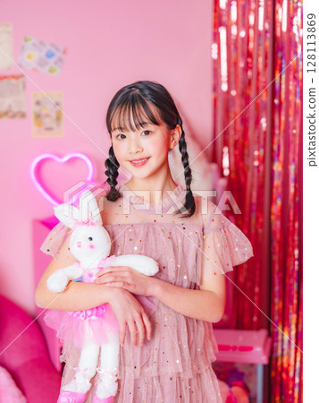 Portrait of a girl taken in a pink room Portrait of a girl taken in a pink room 128113869