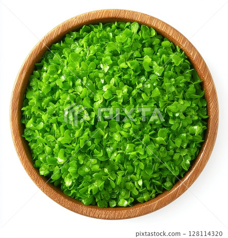 Ready to eat, the fenugreek microgreens in a wooden bowl consist of green sprouts and shoots of Trigonella foenum-graecum, used as an herb, a vegetable, and in the practice of traditional medicine, 128114320