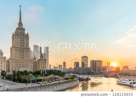 High-rise stalinist building near river at summer sunset in Moscow, Russia. Historic name is Hotel Ukraine. 128115033