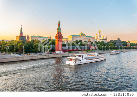 View of Kremlin with Vodovzvodnaya tower, Grand Kremlin Palace from repaired Bolshoy Kamenny Bridge in Moscow city on sunny summer day. Cruise ship sails on the Moscow river View of Kremlin with Vodovzvodnaya tower, Grand Kremlin Palace from repaired Bolshoy Kamenny Bridge in Moscow city on sunny summer day. Cruise ship sails on the Moscow river 128115056