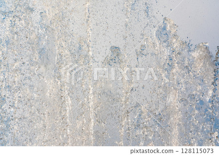 Splashes and jets of water against light background. 128115073