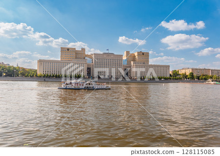 View of the Ministry of Defence of Russian Federation, and Moscow river embakment with cruise ships at sunset. 128115085
