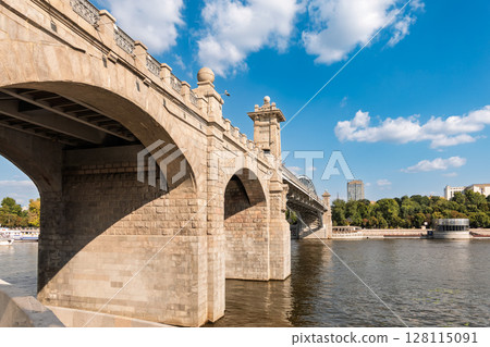 View of the Moscow river embankment, Pushkinsky bridge and cruise ships at sunset. 128115091