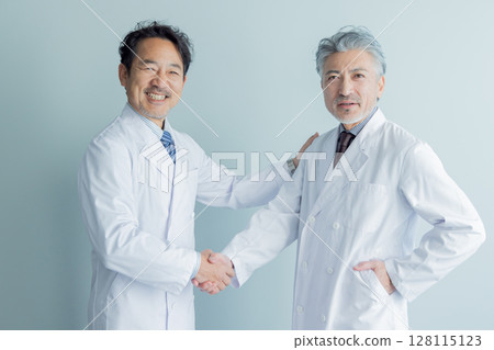 Middle-aged man in a white coat shaking hands 128115123