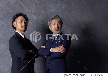 Executive middle-aged male businessman looking up 128115429