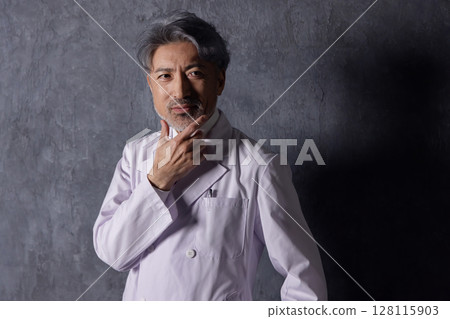 Confident middle-aged male doctor Confident middle-aged male doctor 128115903