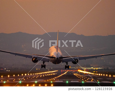 Jet plane landing at dusk 128115916